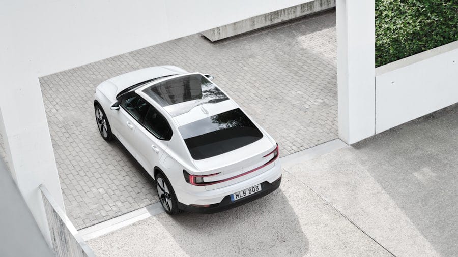 White Polestar 2 driving out from a building.
