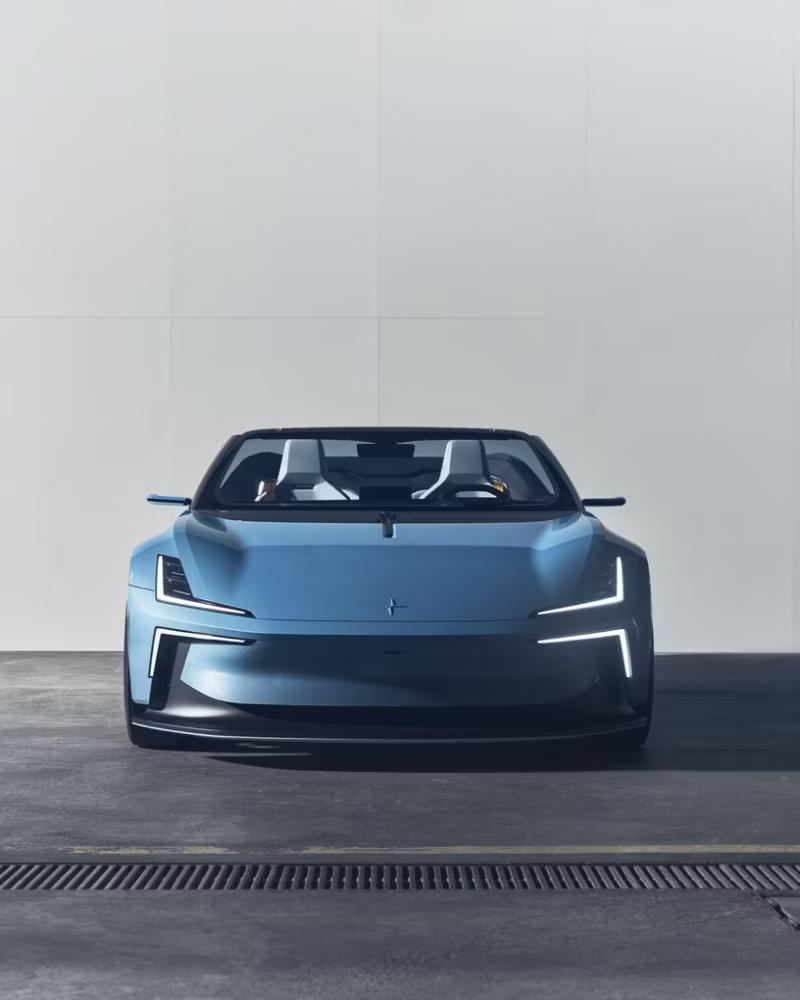 Front view of a Polestar car in a garage setting with white wall background.