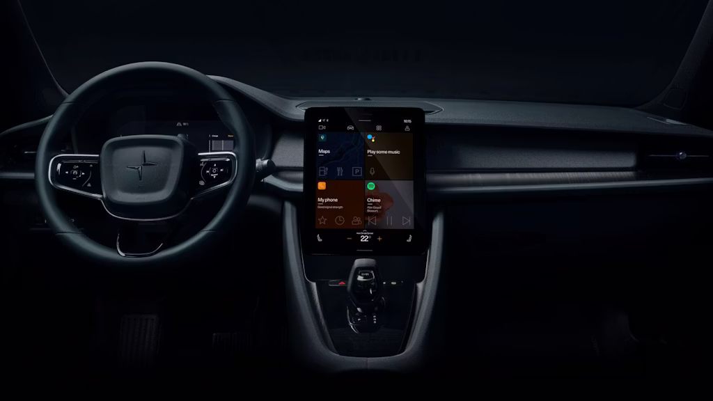Interior of a Polestar 2 with steering wheel on the left and lit up infotainment in the middle showing the apps Google Maps, Voice assistant, Phone and Spotify