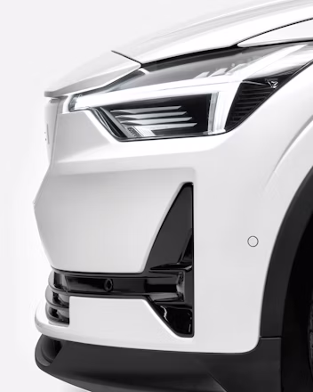 Close-up of Polestar 2 in Snow color, profile view highlighting the headlights