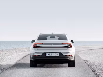 Rear view of Polestar 2 on a beach road