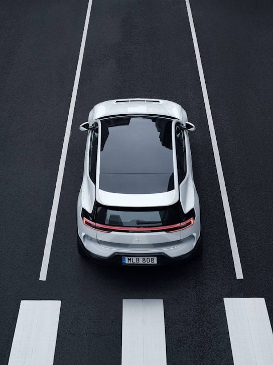 Birds eye view of a white Polestar in front of a pedestrian crossing