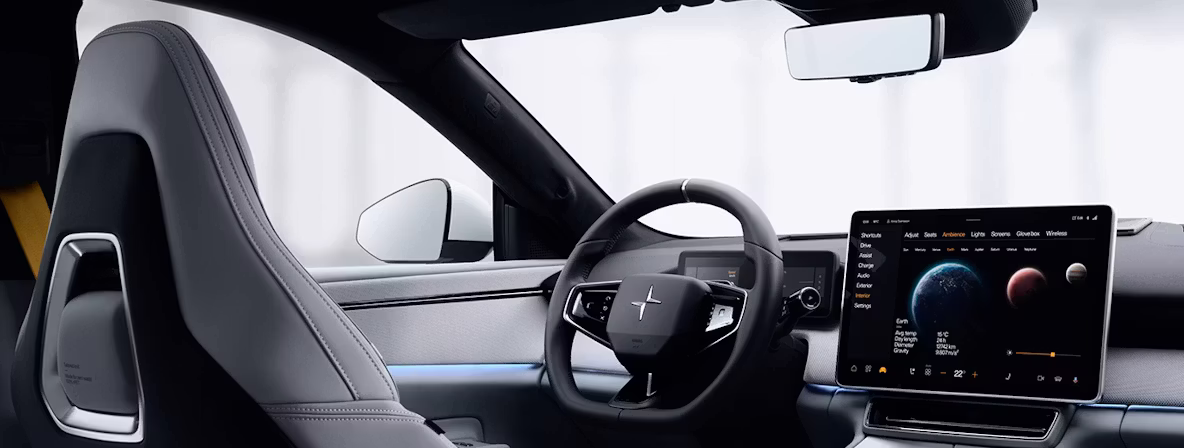 Interior of Polestar car showing steering wheel, dashboard, and touchscreen display with planetary graphics.