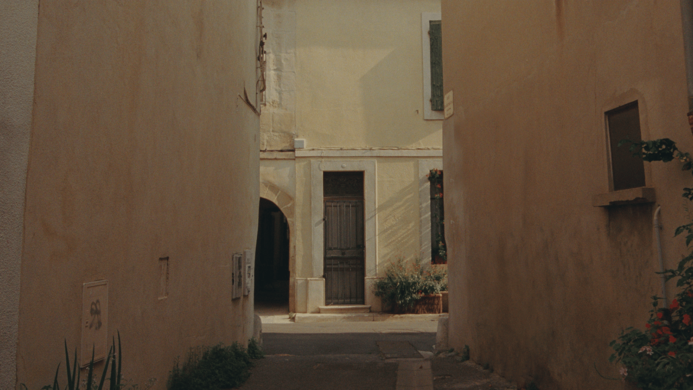 Polestar 2 driven through narrow streets and on a motorway by the side of a mountain.