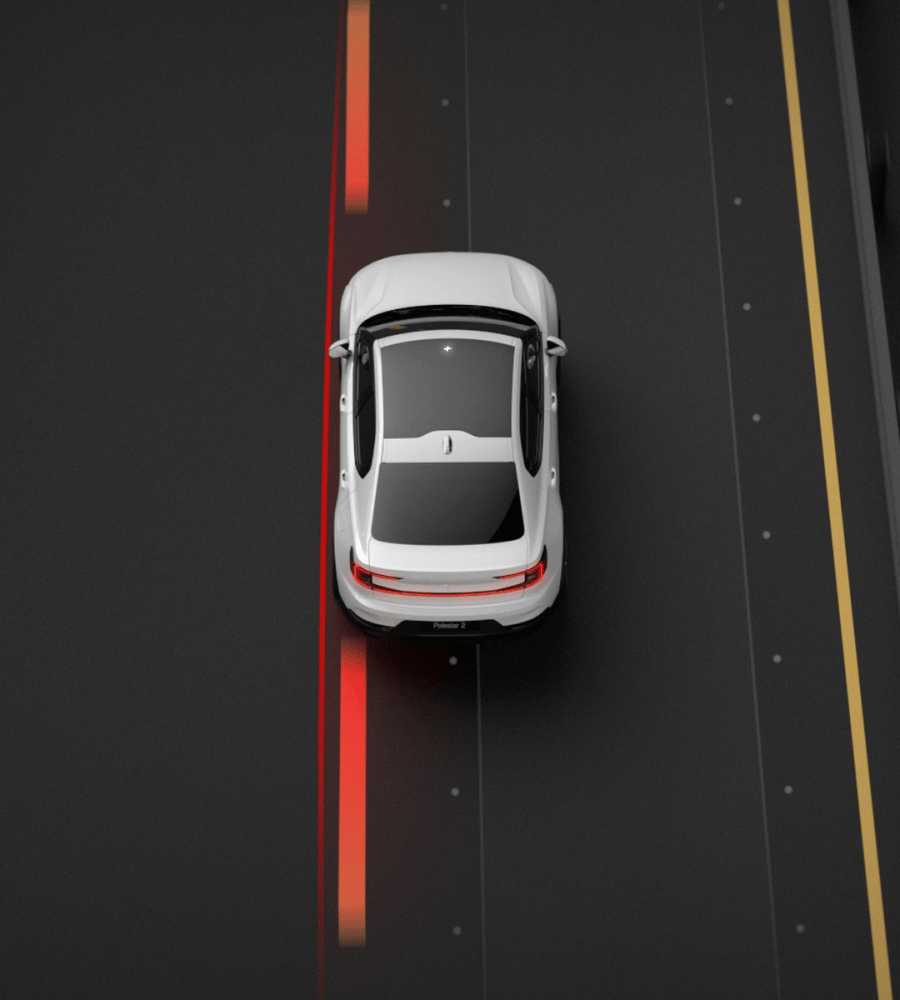 Polestar 2 safely steering back into its lane to avoid colliding with oncoming traffic.