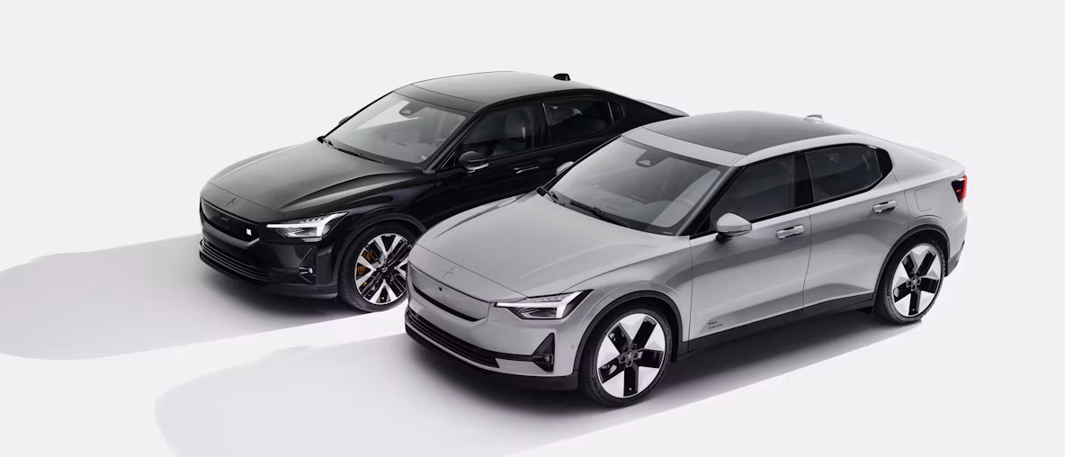 Two Polestar cars parked side by side, one black and one silver, viewed from an elevated angle on a white background.