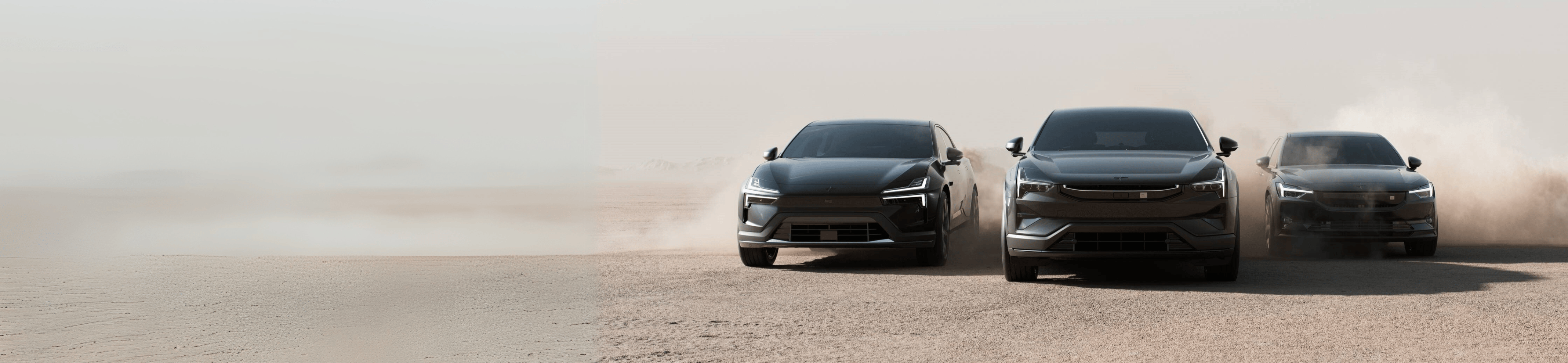 Three Polestar cars driving on a dusty terrain with visible dust clouds in the background.