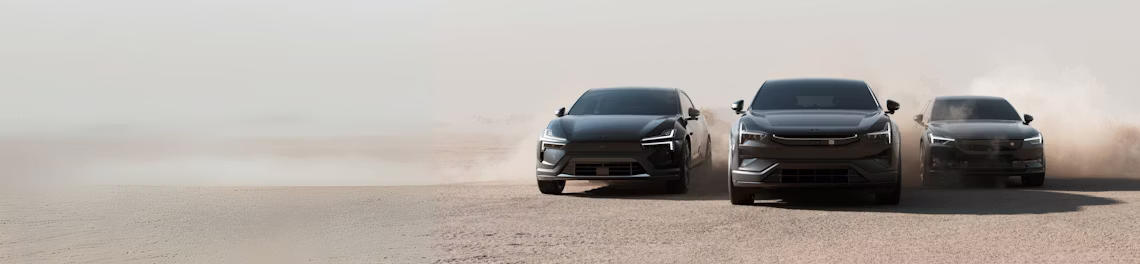 Three Polestar cars driving on a dusty terrain with visible dust clouds in the background.