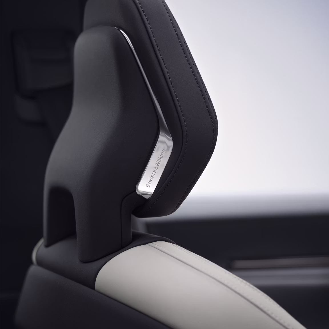 A close up view of Polestar 3’s front seat headrest with the Bowers & Wilkins metal logo.