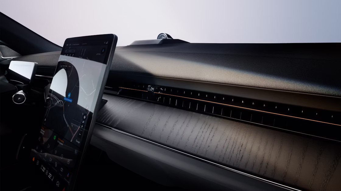 A panned view of Polestar 3’s dashboard in Charcoal colour, centre display, and windscreen.
