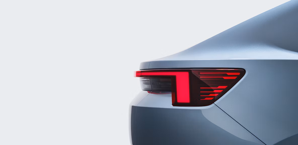 Close up view of the tail light of a light blue coloured Polestar 4 against a white backdrop.