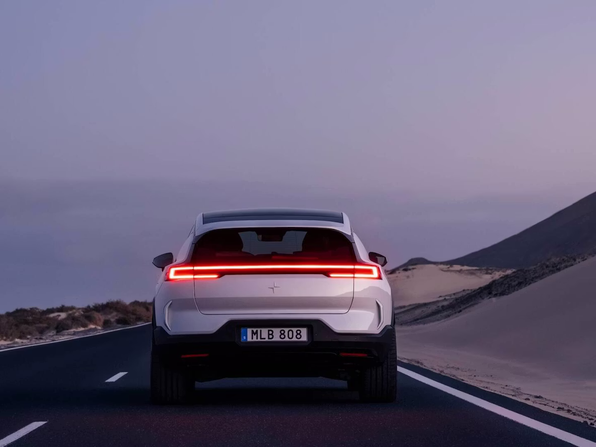 Polestar 3 viewed from behind on a road at dusk.