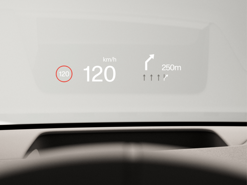 Graphical head-up display on the windscreen showing the current speed and upcoming turn information.