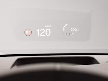 Graphical head-up display on the windscreen showing the current speed and upcoming turn information.