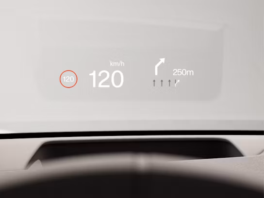 Graphical head-up display on the windscreen showing the current speed and upcoming turn information.