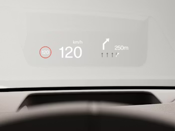 Graphical head-up display on the windscreen showing the current speed and upcoming turn information.
