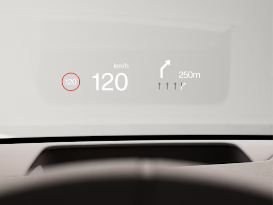 Graphical head-up display on the windscreen showing the current speed and upcoming turn information.