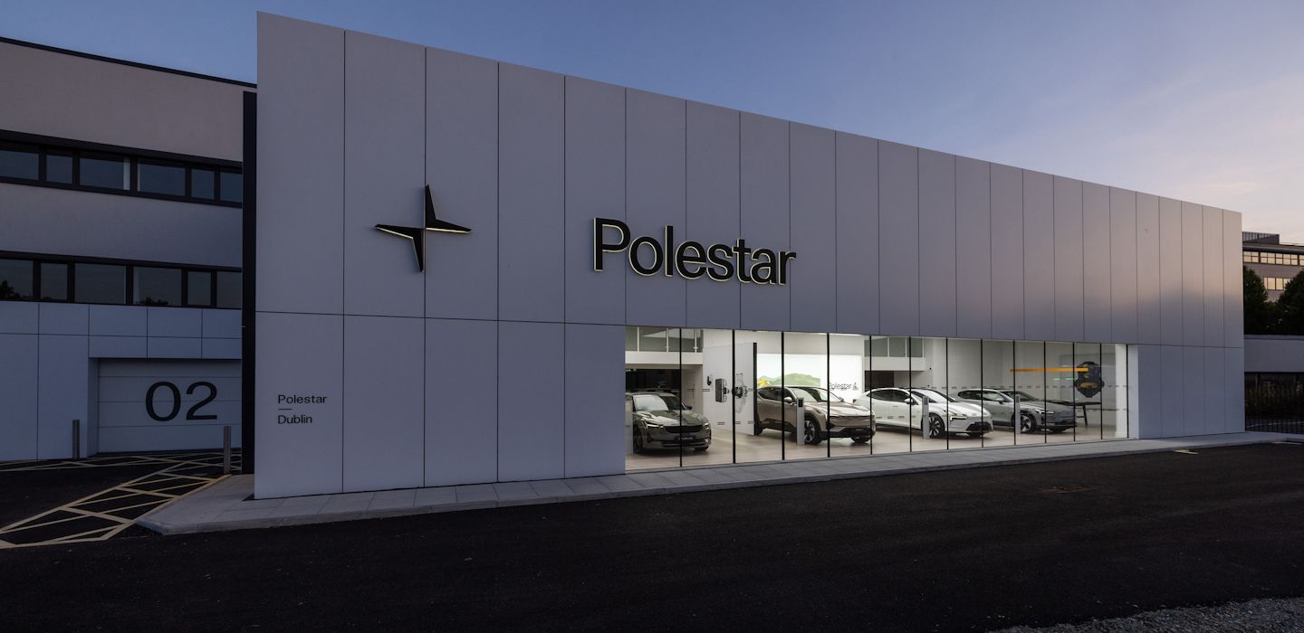 Polestar space white building with cars showing thru the front glass section