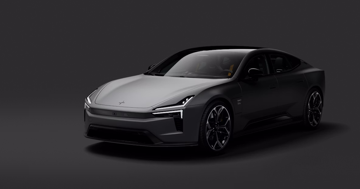 Polestar 5 parked, front three-quarter view, headlights on, studio background