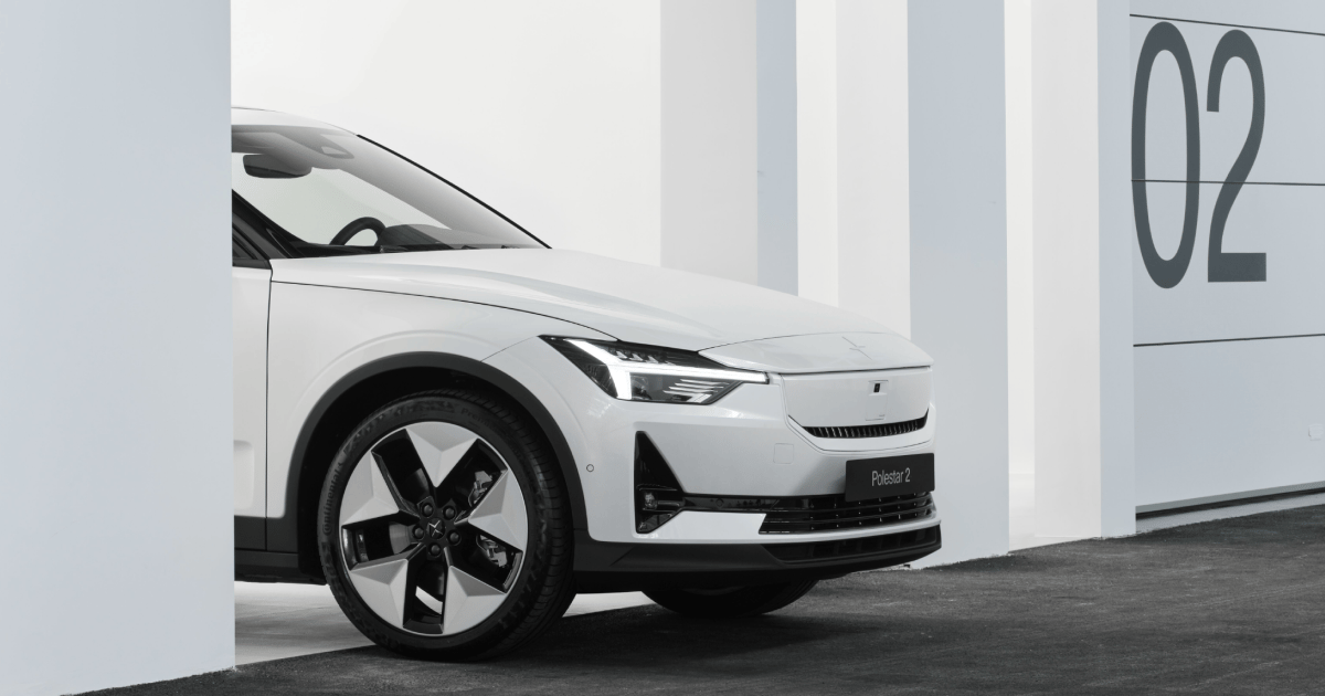 Polestar 2 car partially visible between white pillars with number 02 on the wall in the background.