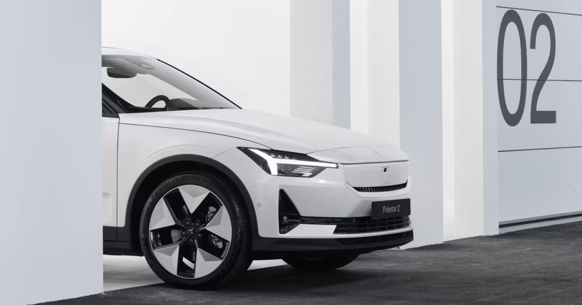 Polestar 2 car partially visible between white pillars with number 02 on the wall in the background.