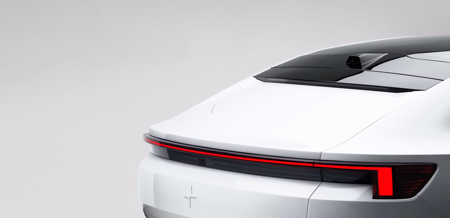 Rear view of Polestar 4 with red tail lights and black roof detail.