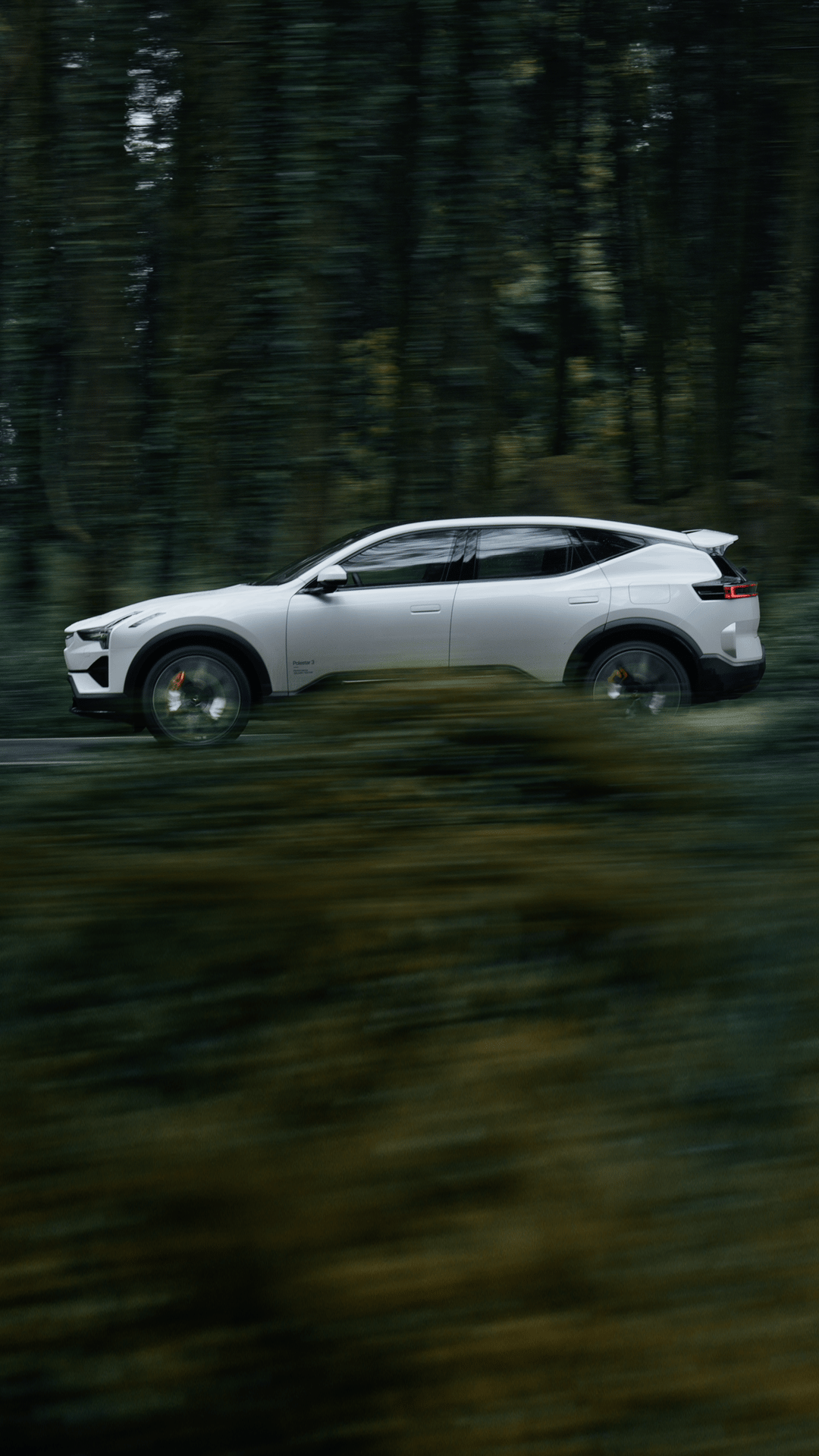 Multiple angles of Polestar 3 in Snow colour driving along the coast and hills.