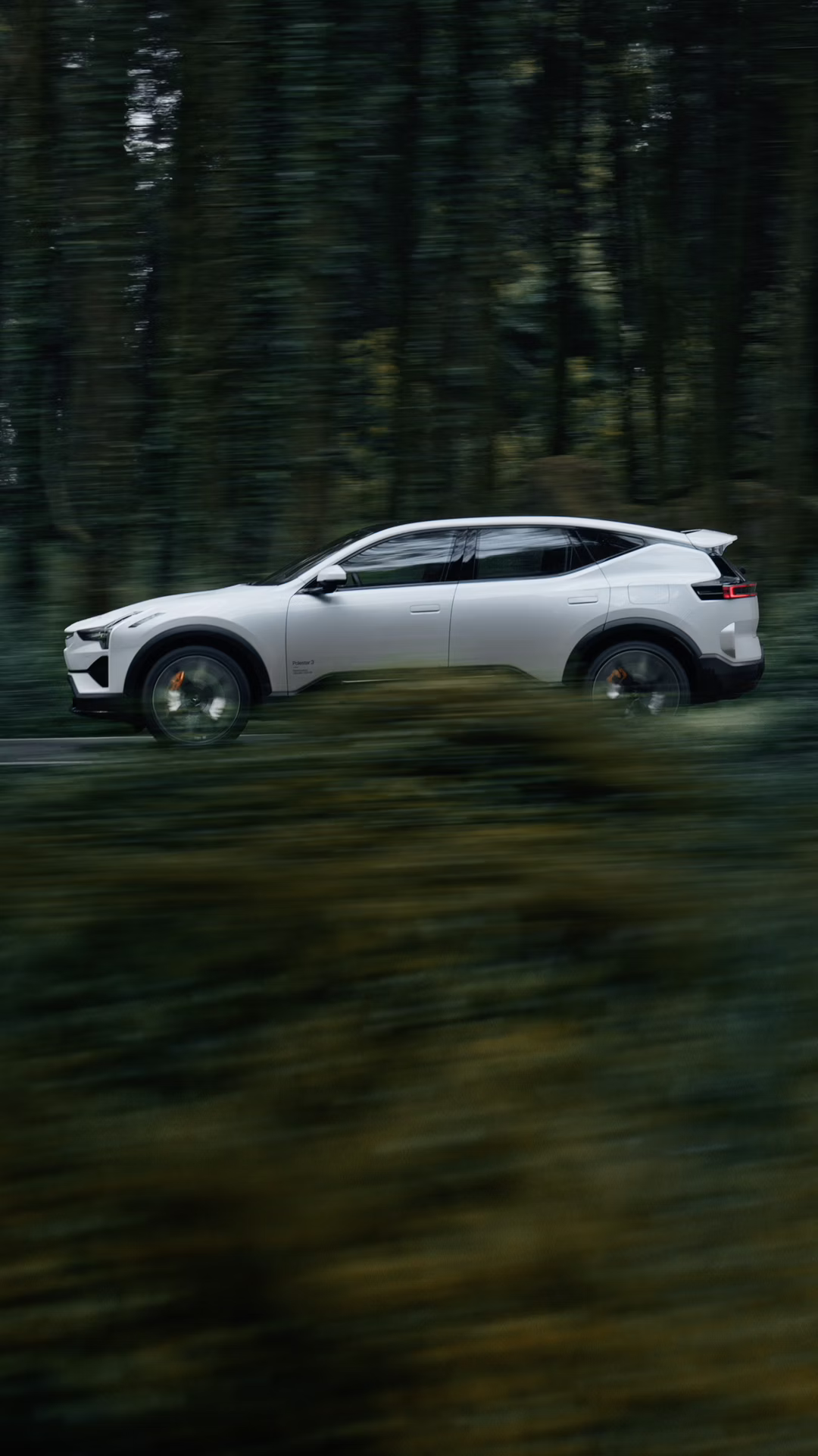 Multiple angles of Polestar 3 in Snow colour driving along the coast and hills.