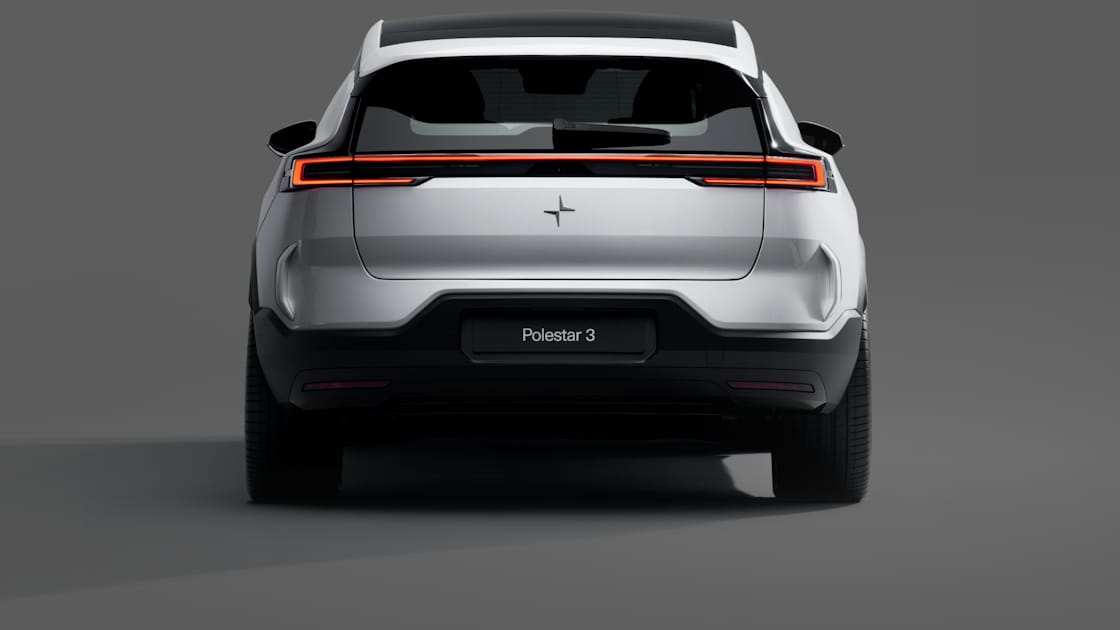 A rear view of a white Polestar 3 standing against a grey background.