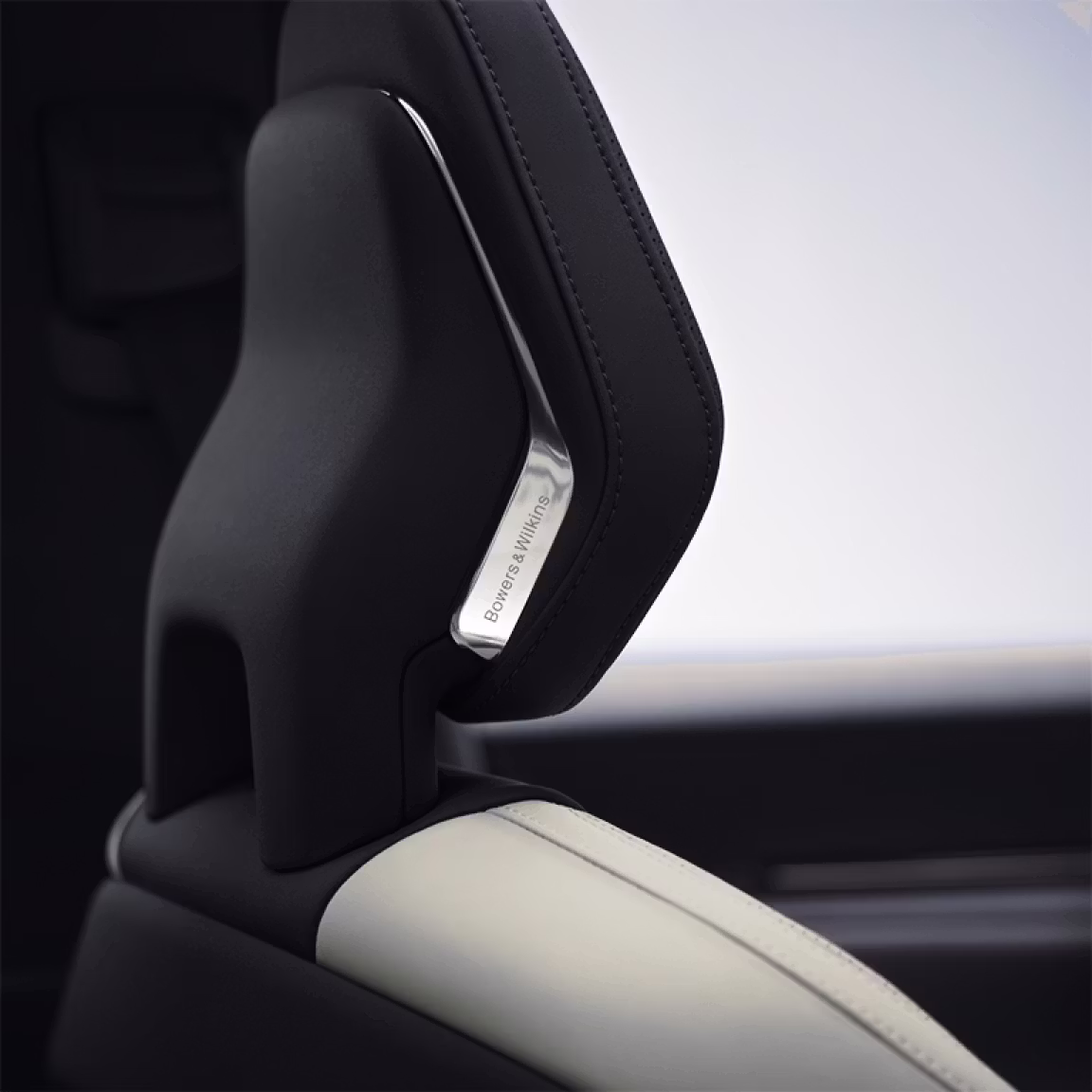 A close up view of Polestar 3’s front seat headrest with the Bowers & Wilkins metal logo.