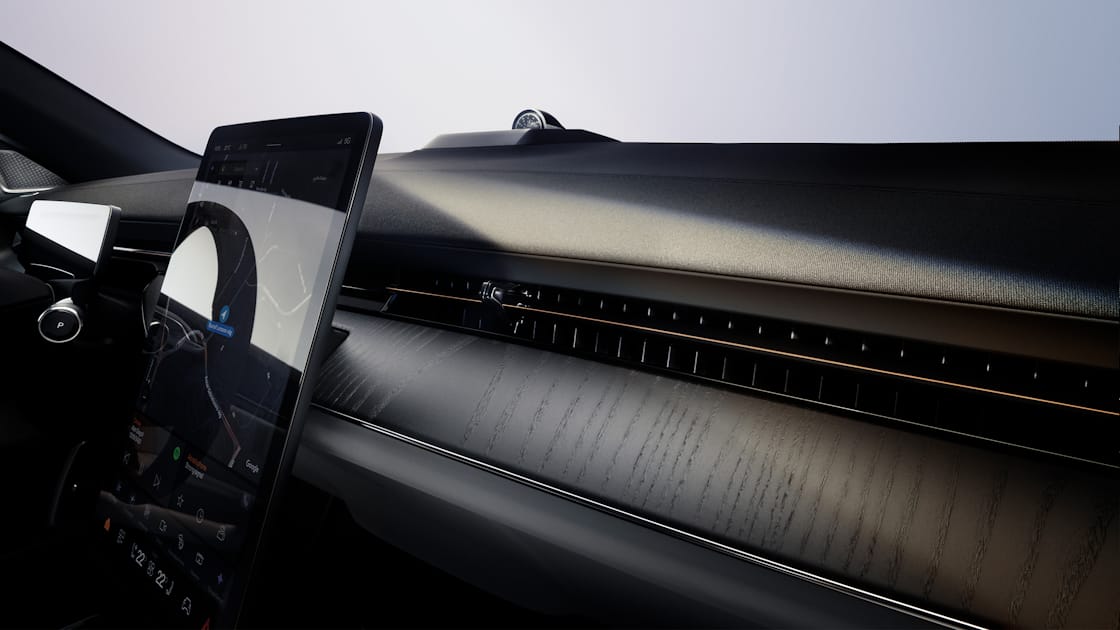 A panned view of Polestar 3’s dashboard in Charcoal colour, centre display, and windscreen.