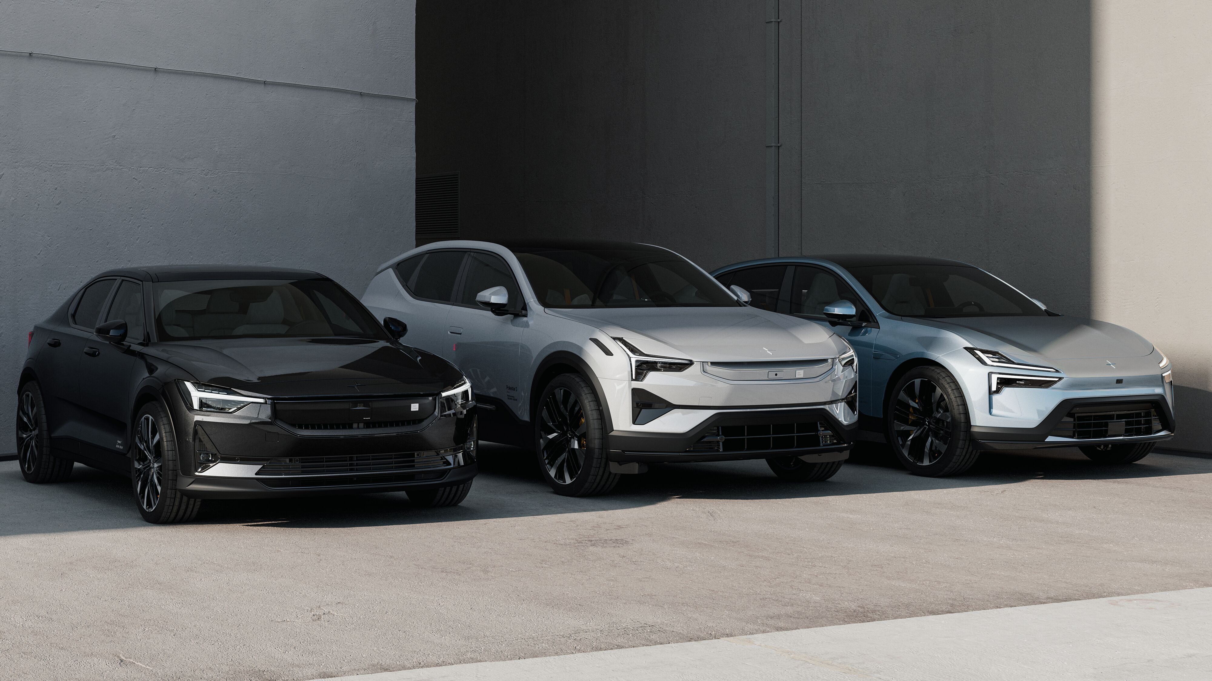 Polestar 2, Polestar 3 & Polestar 4 parked side by side against a wall