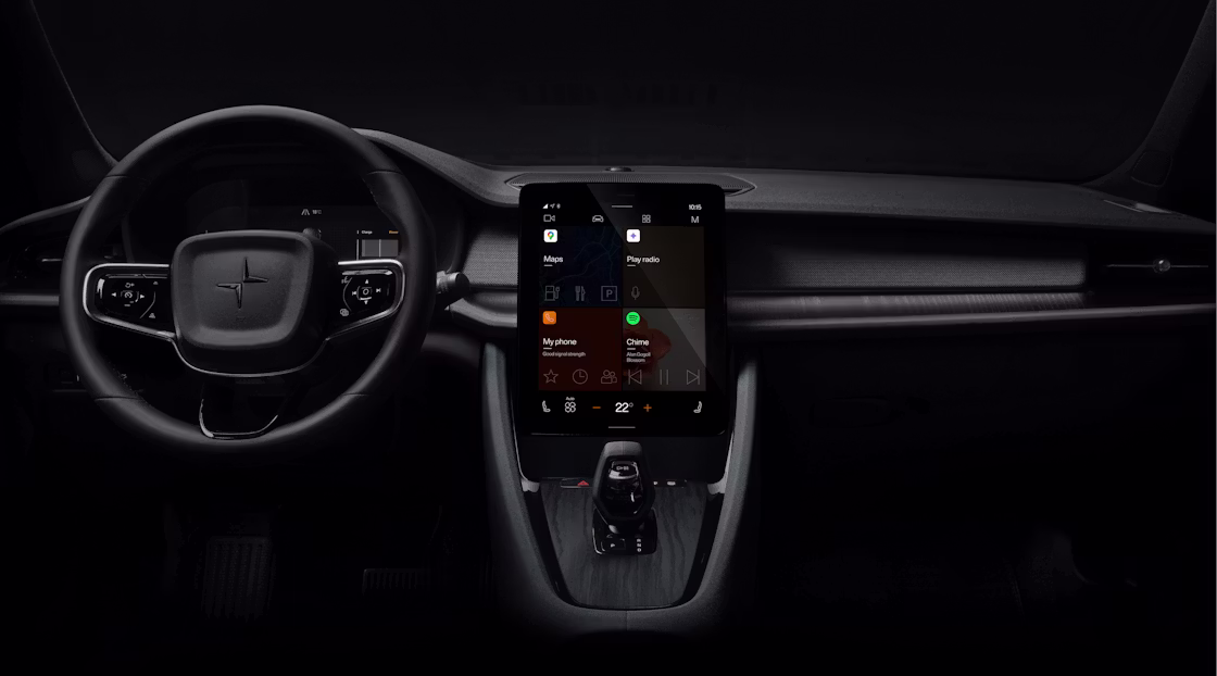 Polestar 2’s dashboard area with the steering wheel and centre display against a dark background.