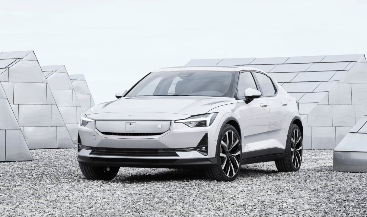 Polestar 2 parked on gravel in front of geometric structures