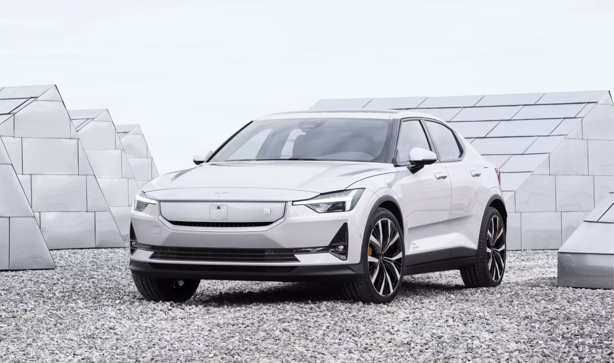 Polestar 2 parked on gravel in front of geometric structures