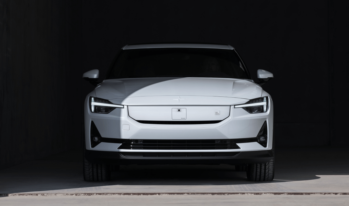 White Polestar 2 facing forward in a dark garage