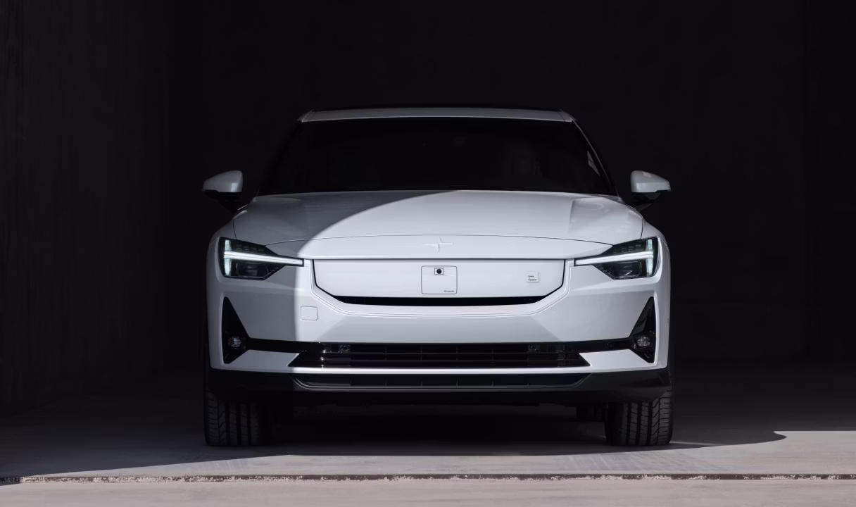 White Polestar 2 facing forward in a dark garage