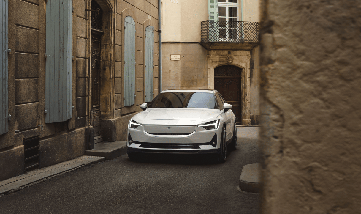 Polestar 2 parked in a narrow street between old buildings