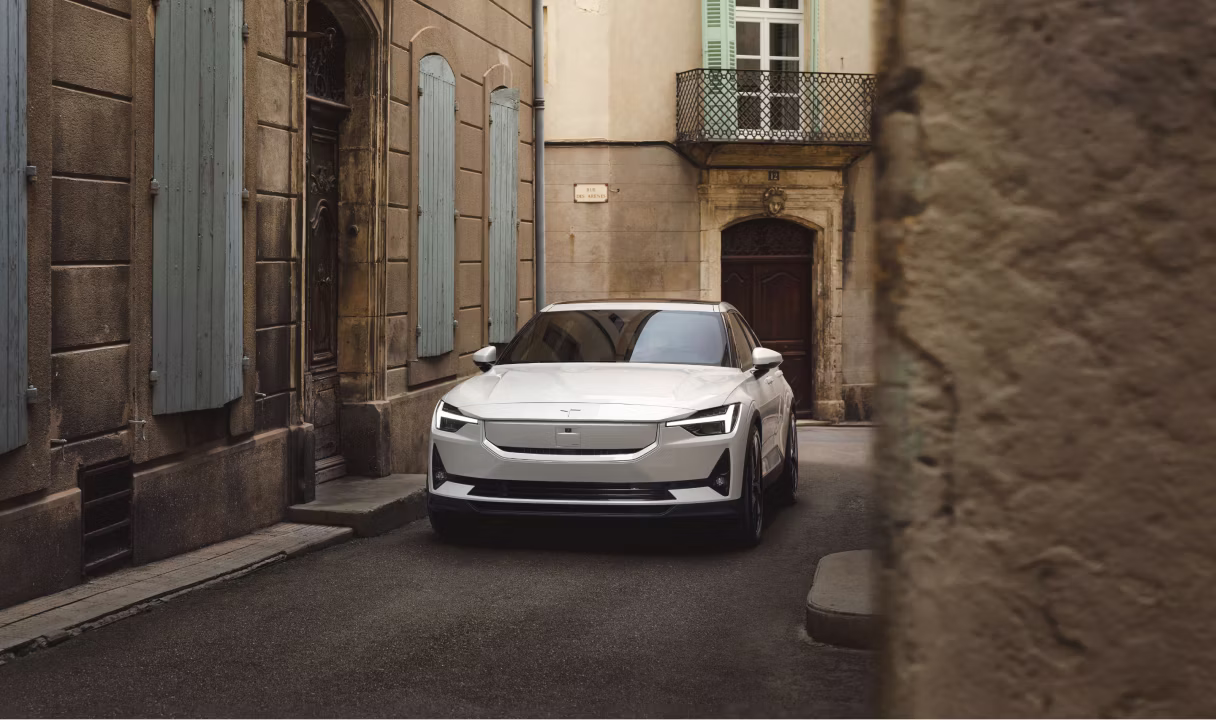 Polestar 2 parked in a narrow street between old buildings