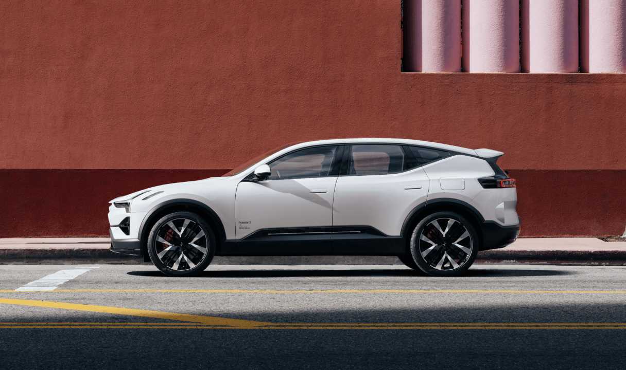 Polestar 3 SUV parked beside a red wall