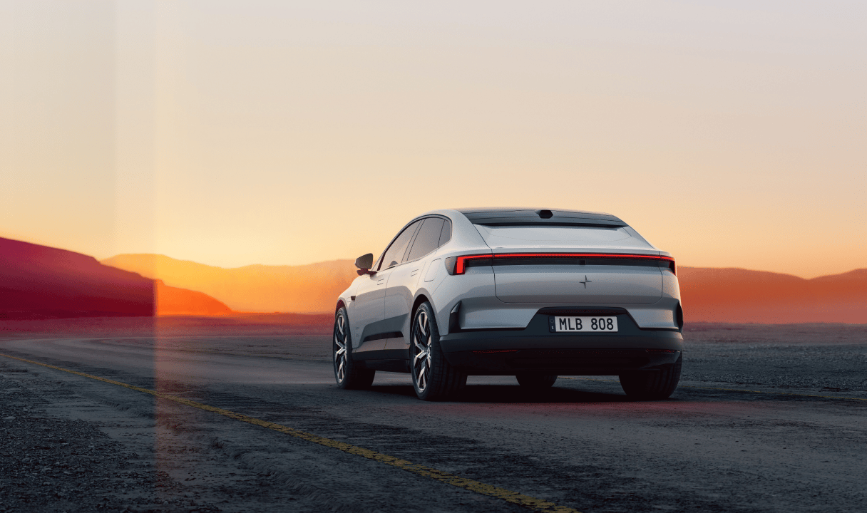 Polestar 4 coupé driving on a road at sunset