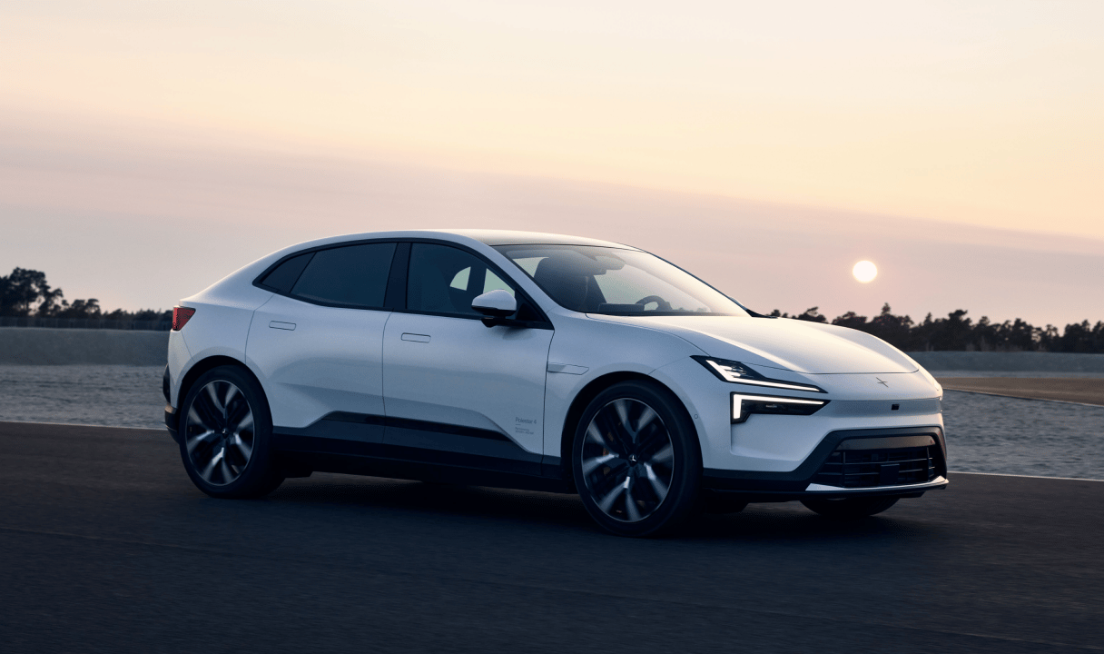 Polestar 4 coupé driving on a road at sunset