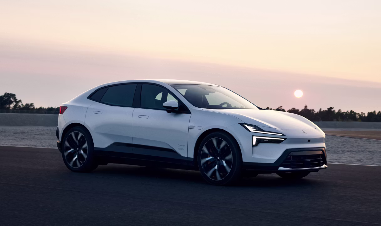 Polestar 4 coupé driving on a road at sunset