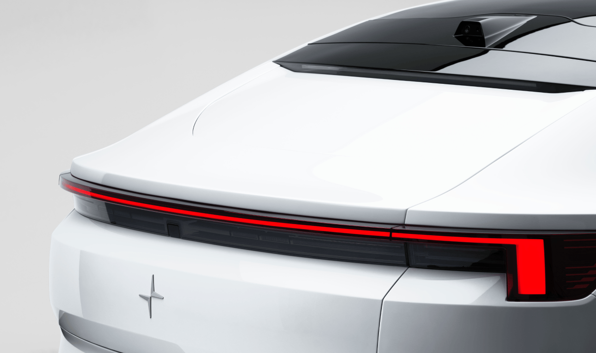 Rear view of a Polestar 4 coupé with a full-width taillight and rear window camera