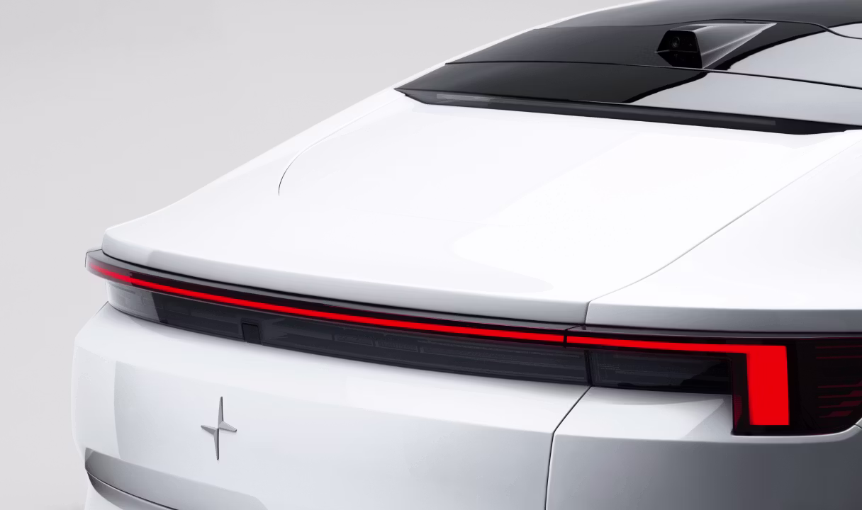 Rear view of a Polestar 4 coupé with a full-width taillight and rear window camera