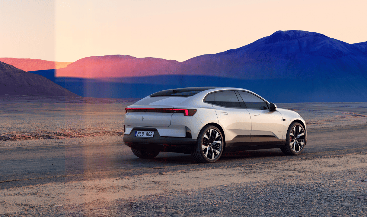 Polestar 4 coupé parked on a desert road with mountains in the background