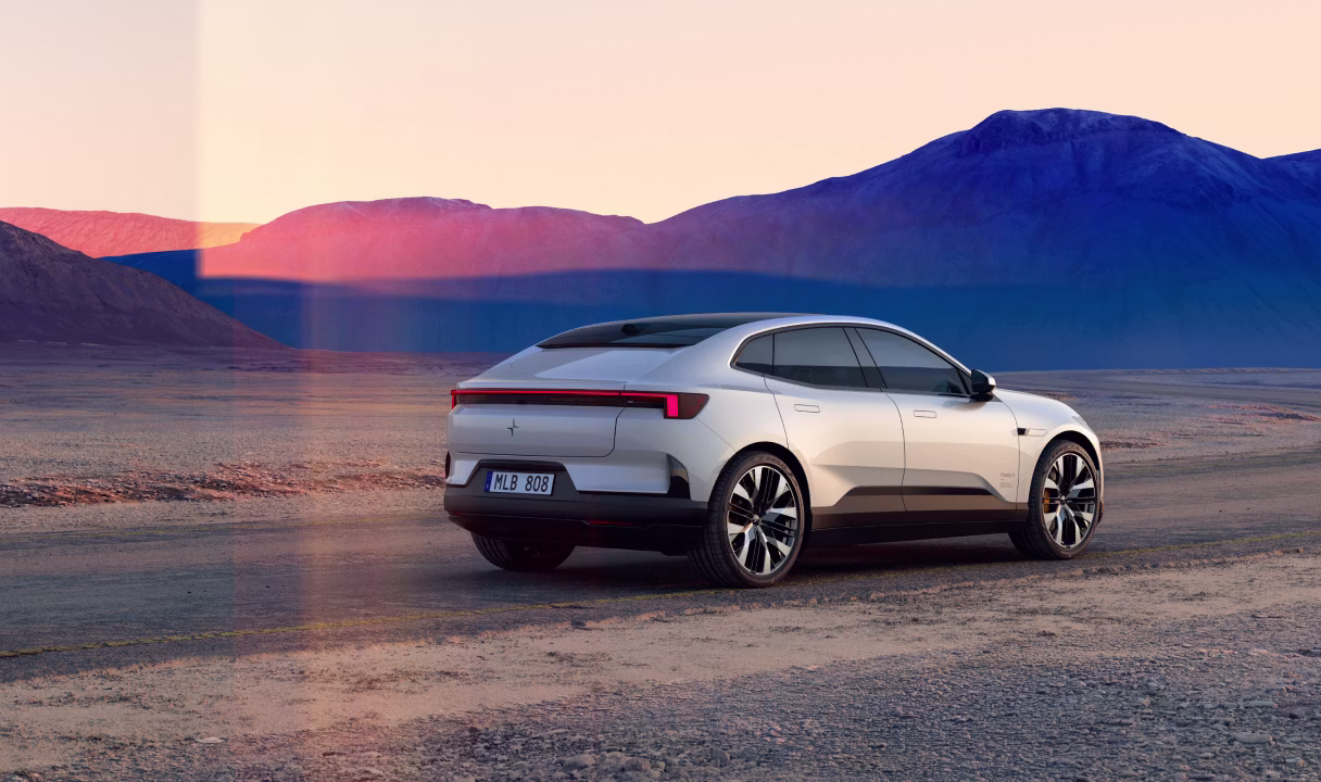 Polestar 4 coupé parked on a desert road with mountains in the background