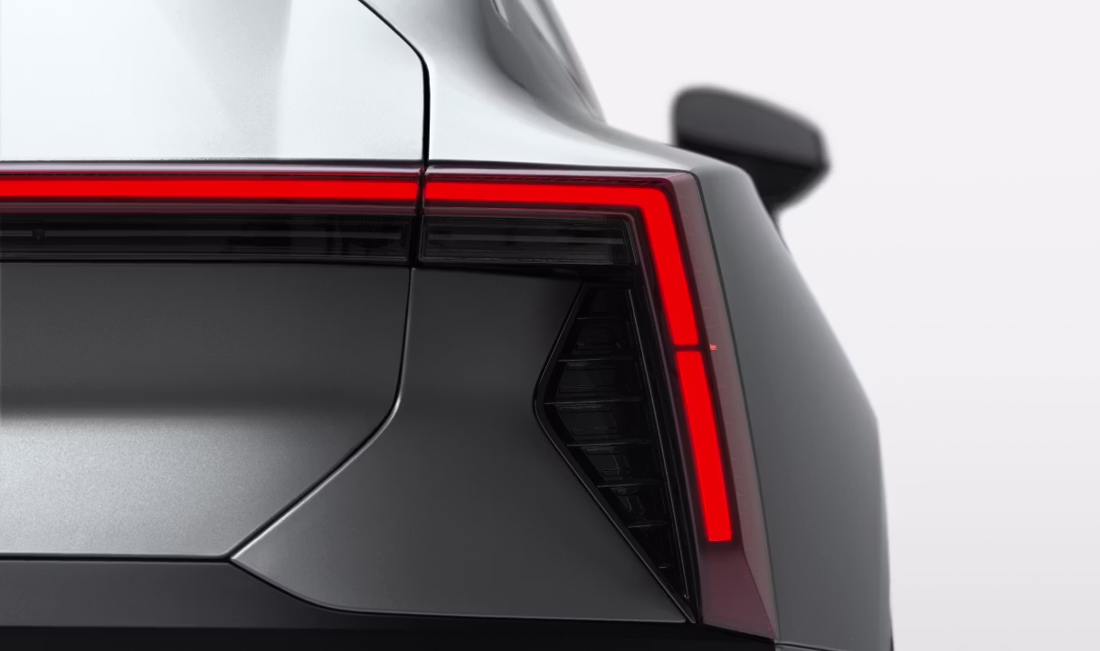 Rear corner of a Polestar 5 with illuminated taillight