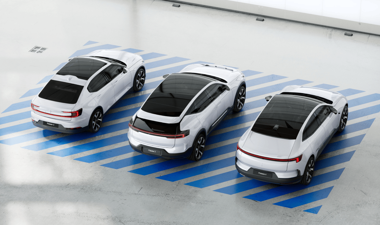 Three Polestar cars parked in a row on blue diagonal stripes