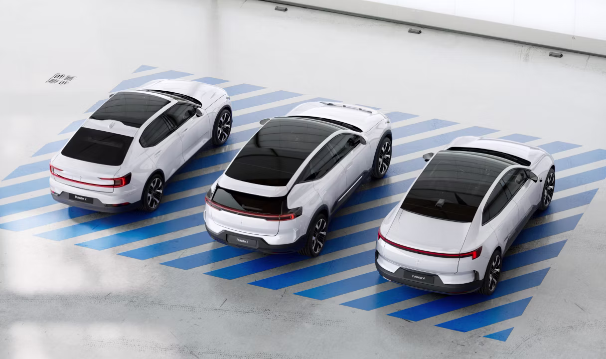 Three Polestar cars parked in a row on blue diagonal stripes